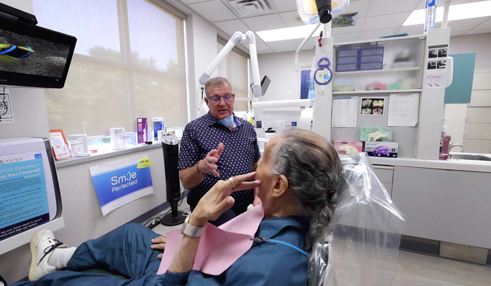 Dr. Butler discussing dental implants with a patient at his Hilliard, OH dental office Innovative Dental Ideas