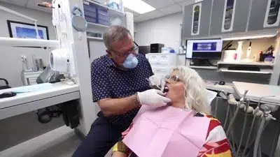 Dr. Hilliard examining female patient's mouth